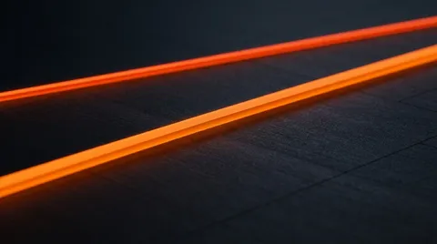 A single unbroken glowing orange line running diagonally across a dark, textured charcoal surface.