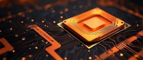 Close-up of an orange-glowing microchip seated on a dark circuit board.